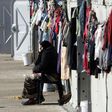 A woman smokes a cigarette at a refugee camp in Thessaloniki