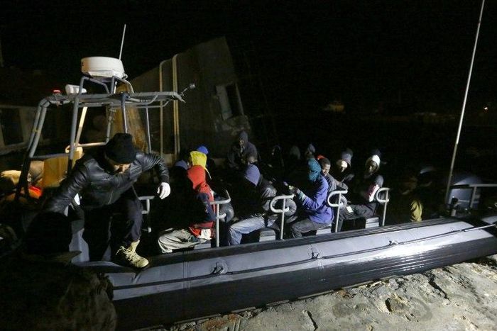 Libyan coastguards help migrants who were rescued at sea off the coast of Tripoli, on February 5, 2017