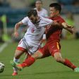 Syria's Mahmoud Al-Mawas (L) fights for the ball with Vietnam's Tran Dinh Dong during a friendly at Hanoi's My Dinh stadium on May 31, 2016