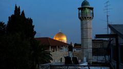 The minaret of a mosque and the Dome of the Rock in a Palestinian neighbourhood in east Jerusalem's Old City