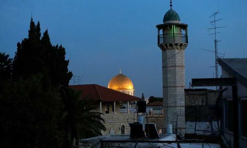 The minaret of a mosque and the Dome of the Rock in a Palestinian neighbourhood in east Jerusalem's Old City