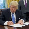 US President Donald Trump signs an executive order withdrawing the US from the Trans-Pacific Partnership in the Oval Office of the White House on January 23, 2017