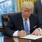 US President Donald Trump signs an executive order withdrawing the US from the Trans-Pacific Partnership in the Oval Office of the White House on January 23, 2017