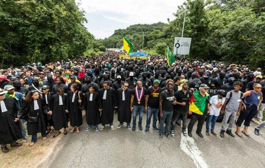 Demonstrators and lawyers stand during a protest over security and the state of the economy near the Centre Spatial Guyanais on April 4, 2017 in Kourou, French Guiana