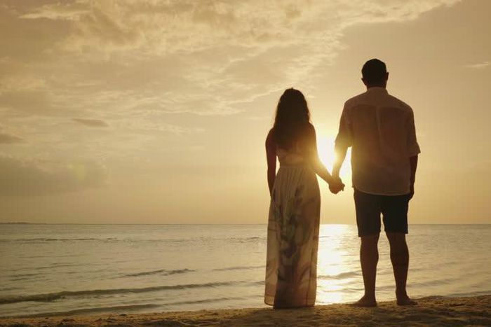 Stock photo of a couple's silhouette on a beach [Credit - Shutterstock]