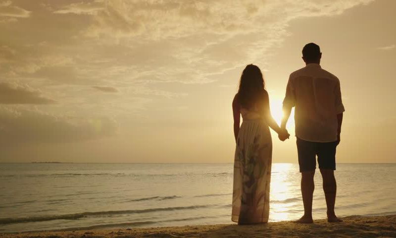 Stock photo of a couple's silhouette on a beach [Credit - Shutterstock]