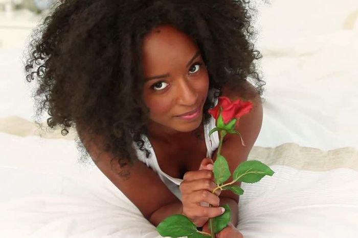 Woman holding a rose flower(footage.framepool)