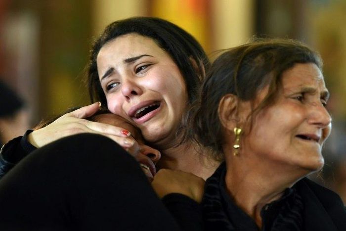 Women mourn the victims of the blast at Saint Mark's church in Egypt's Alexandria during a funeral procession on April 10, 2017