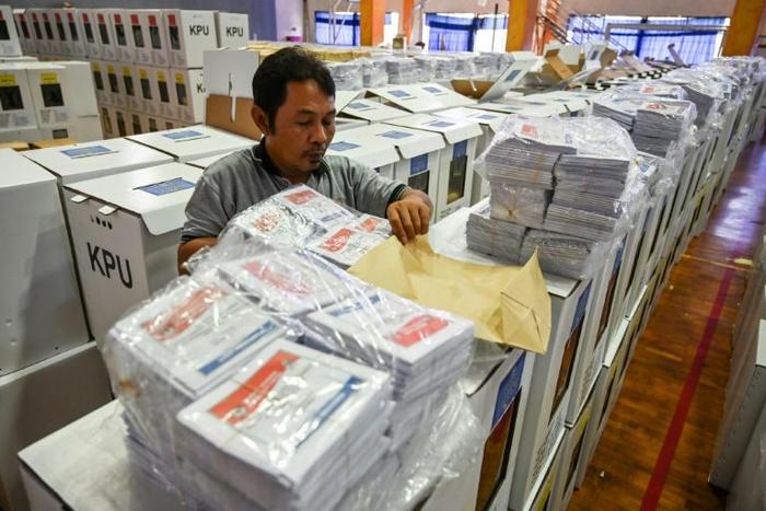 An official prepares ballot boxes and other voting materials in Jakarta ahead of elections next week. Indonesia is investigating vote-rigging claims after thousands of ballot papers were disovered in neighbouring Malaysia