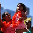 A mother and daughter cheer at the "A Day Without a Woman" rally honoring International Women's Day, in Los Angeles, California