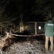 A policeman stands in front of an entrance leading to the site where six teenagers were found dead after holding a party in a garden near Arnstein, southern Germany, on January 29, 2017