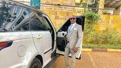 File image of controversial politician Steve Mbogo standing next to one of the high-end vehicles in his fleet DCI has impounded one of his Range Rovers