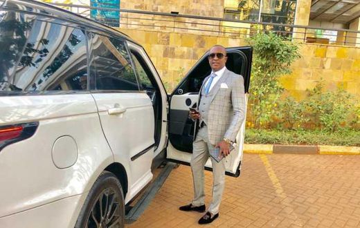 File image of controversial politician Steve Mbogo standing next to one of the high-end vehicles in his fleet DCI has impounded one of his Range Rovers