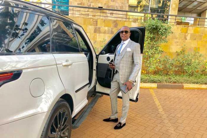 File image of controversial politician Steve Mbogo standing next to one of the high-end vehicles in his fleet DCI has impounded one of his Range Rovers