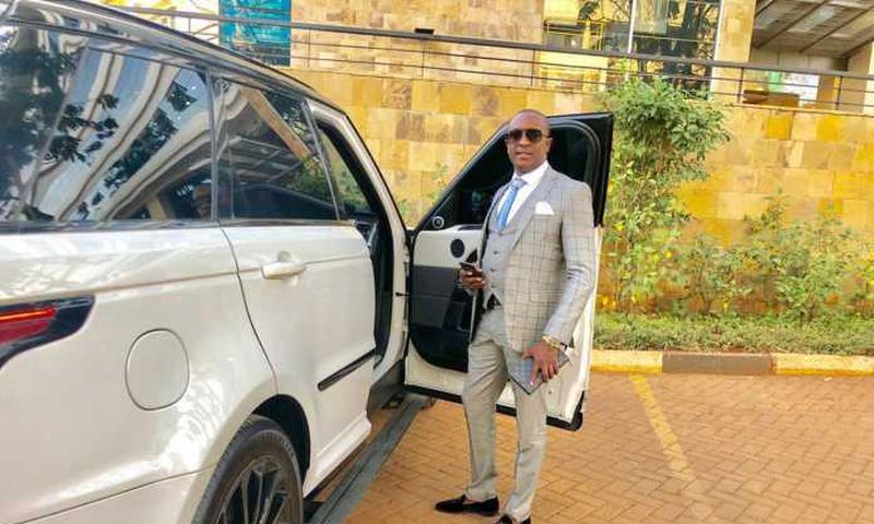 File image of controversial politician Steve Mbogo standing next to one of the high-end vehicles in his fleet DCI has impounded one of his Range Rovers