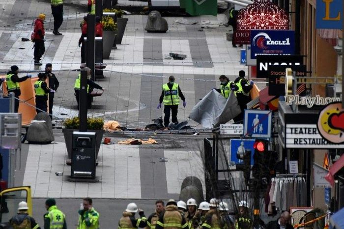 Emergency services work at the scene where a truck crashed into the Ahlens department store at Drottninggatan in central Stockholm, April 7, 2017