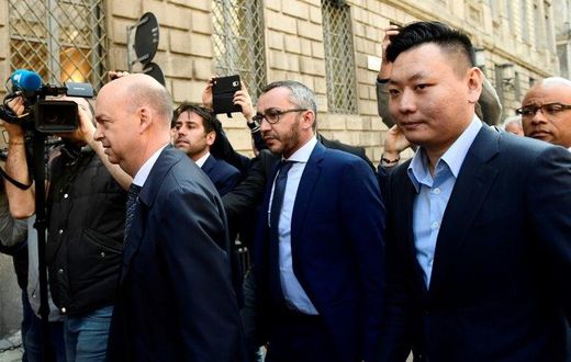 Han Li (R) and Marco Fassone (L), representatives of Chinese consortium Sino-Europe Sports (SES), arrive in Milan to finalize the deal with Fininvest for AC Milan's takeover by Rossoneri Sport Investment Lux on April 13, 201