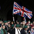 Supporters of former British soldier Alexander Blackman, react outside The Royal Courts of Justice after his sentence was reduced from murder to manslaughter