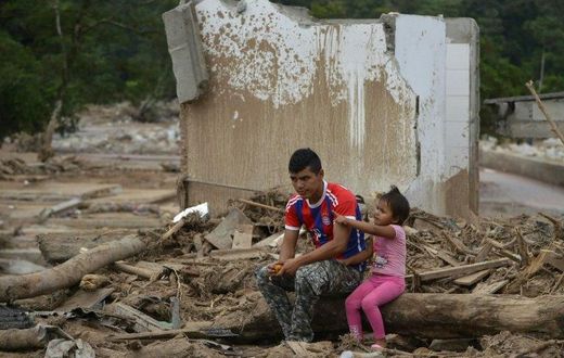 A man and his daughter remain amid rubble in Mocoa, Putumayo department, Colombia on April 4, 2017