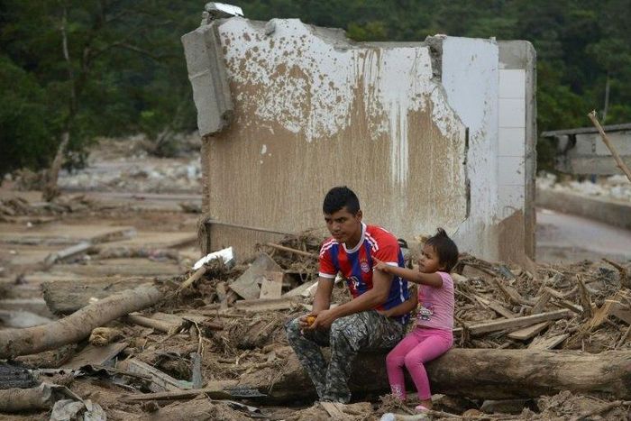 A man and his daughter remain amid rubble in Mocoa, Putumayo department, Colombia on April 4, 2017