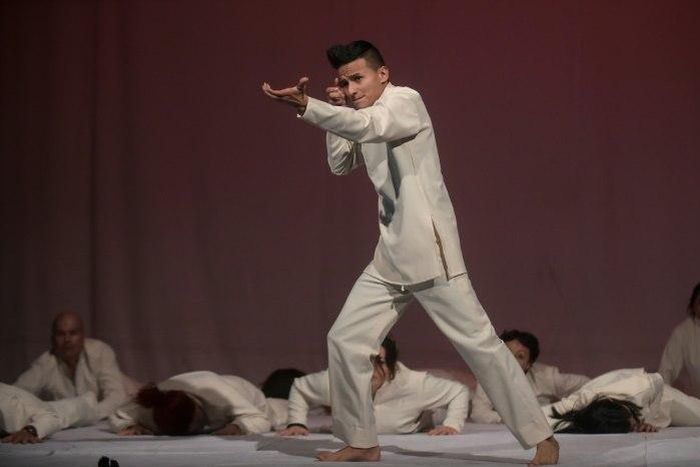 A former member of an armed group, Dereck Anderson (C), performs during the Victus II Memory theater project, in Bogota on May 11, 2017