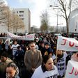 People holding signs reading "Justice for Theo" march through Aulnay-sous-Bois, north of Paris