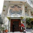 A bellboy stands outside UK street artist Banksy's newly-opened Walled Off hotel in the West Bank town of Bethlehem, on March 3, 2017