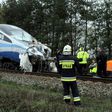 Emergency services work at the scene of a collision between a train and a truck in Schodnia, south Poland, on April 7, 2017
