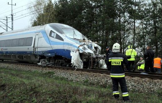 Emergency services work at the scene of a collision between a train and a truck in Schodnia, south Poland, on April 7, 2017