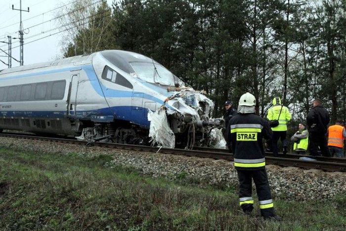 Emergency services work at the scene of a collision between a train and a truck in Schodnia, south Poland, on April 7, 2017
