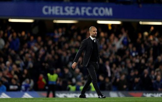 Manchester City manager Pep Guardiola crosses the pitch following his side's English Premier League match against Chelsea at Stamford Bridge in London on April 5, 2017