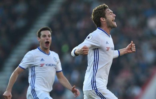 Chelsea's Marcos Alonso (R) celebrates scoring their third goal from a free kick during their match against Bournemouth at the Vitality Stadium in Bournemouth, southern England on April 8, 2017