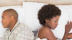 Estranged couple in bed