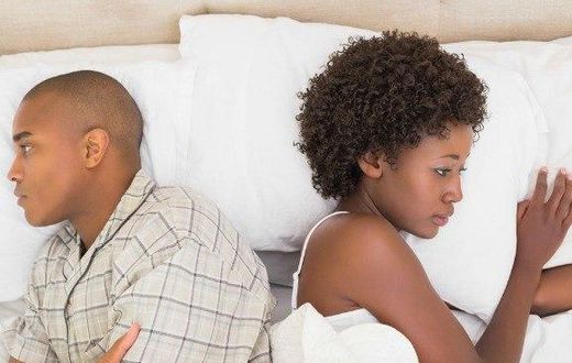 Estranged couple in bed