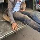 Naftali Njahi Kinuthia at the back of a police Land Cruiser after he was stoned by bodaboda operators outside Moi Teaching and Referral Hospital (Twitter)