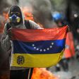 A hooded demonstrator protests against the government of President Nicolas Maduro in Caracas on May 31, 2017