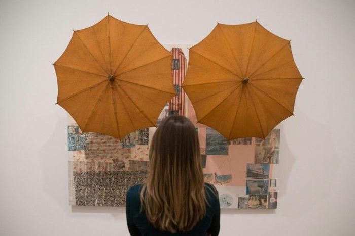 A woman looks at an art work entitled 'Untitled (Spread), 1983' by US artist Robert Rauschenberg during a press preview at the Tate Modern in London on November 29, 2016