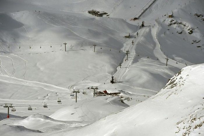 A late-season avalanche killed two skiers and their guide in the French Alps near the Italian border, local officials said
