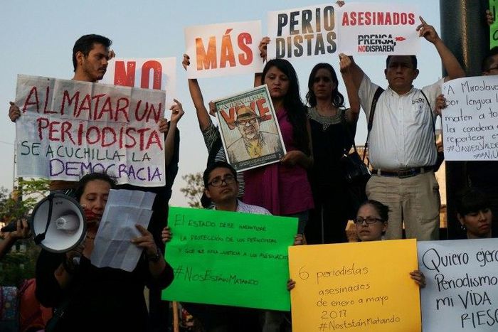 Journalists hold signs condemning violence against journalists while protesting the recent murder of the of Mexican journalist Javier Valdez on May 16, 2017 in Guadalajara