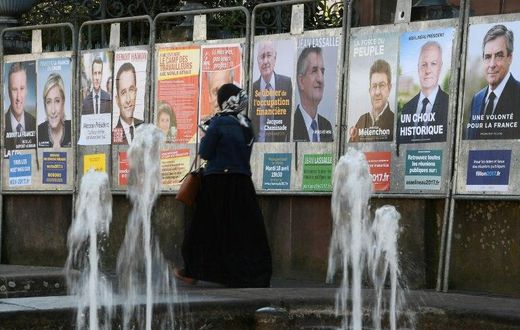 Campaign posters for the French presidential candidates cover a wall in Strasbourg, eastern France