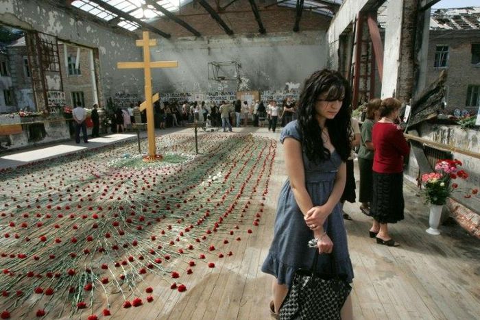 Mourners gather inside the Beslan school gymnasium at the school in North Ossetia on September 1, 2009 as they commemorate the fifth anniversary of the 2004 terrorist massacre