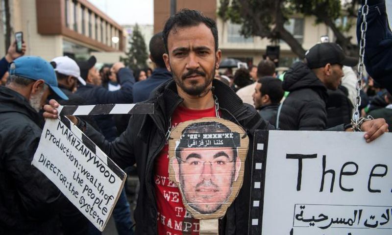 Supporters of Morocco's al-Hirak al-Shaabi movement hold placards and shout slogans calling for the release of the movement's members outside the Casablanca Court of Appeals during their trial on April 5, 2019