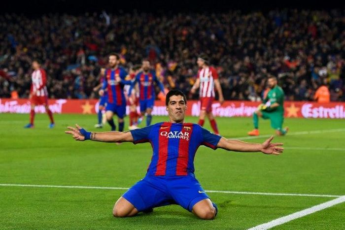 Barcelona's Uruguayan forward Luis Suarez celebrates after scoring the opener during the Spanish Copa del Rey semi final second leg football match against Club Atletico de Madrid at the Camp Nou stadium in Barcelona on February 7, 2017
