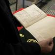 A man reads a manuscript on astronomy by renowned tenth century Muslim philosopher Al-Farabi, at the al-Qarawyin Library on November 21, 2016
