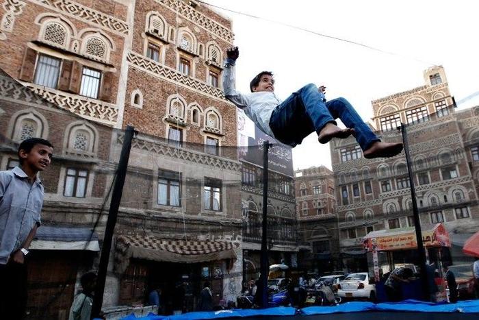 Yemeni children play at a market in the old city of the capital Sanaa on October 21, 2016, as a fragile ceasefire hangs by a thread in the war-torn country
