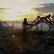 A man builds a tent at sunset in a camp for internally displaced people in Kaga Bandoro, Central African Republic