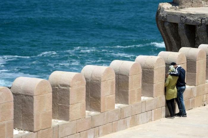 An Egyptian couple embracing during a stroll on Pharos Island in the port of Alexandria