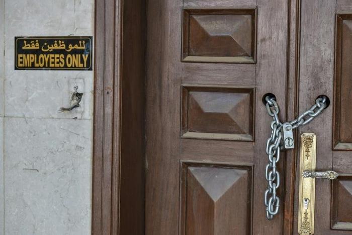 An entrance is locked with a chain at the abandoned headquarters in Riyadh of the Hariri family's collapsed construction giant Saudi Oger