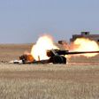 Syrian government forces fire artillery during a battle against the Islamic State group on May 16, 2017 on the edge of Lake Assad in the eastern part of Aleppo province