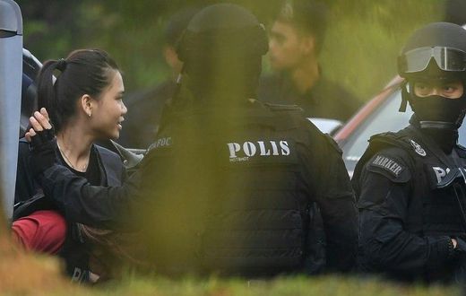 Indonesian national Siti Aisyah, one of the two acused, is taken into court with a Malaysian police escort